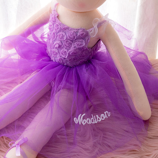 Purple ballerina doll with rose bodice, ribbon-tied shoes, pearl flower in hair, and custom name embroidery