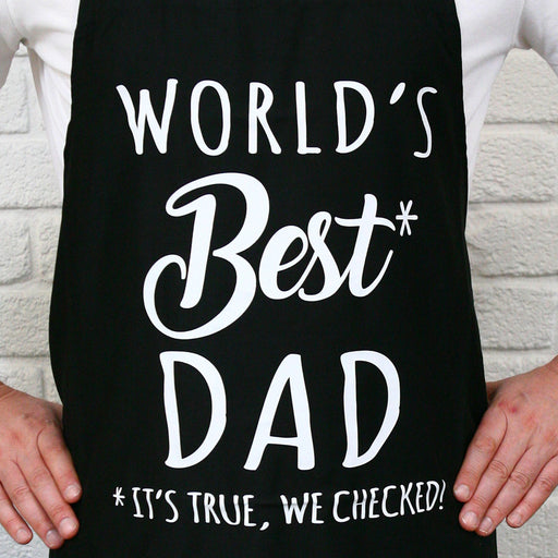 Father wearing World’s Best Dad BBQ apron while cooking at the grill