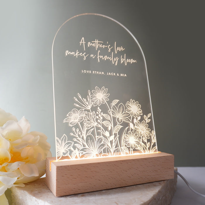 Personalised Mother’s Day night light with custom name and message on clear acrylic, glowing on a wooden LED base.