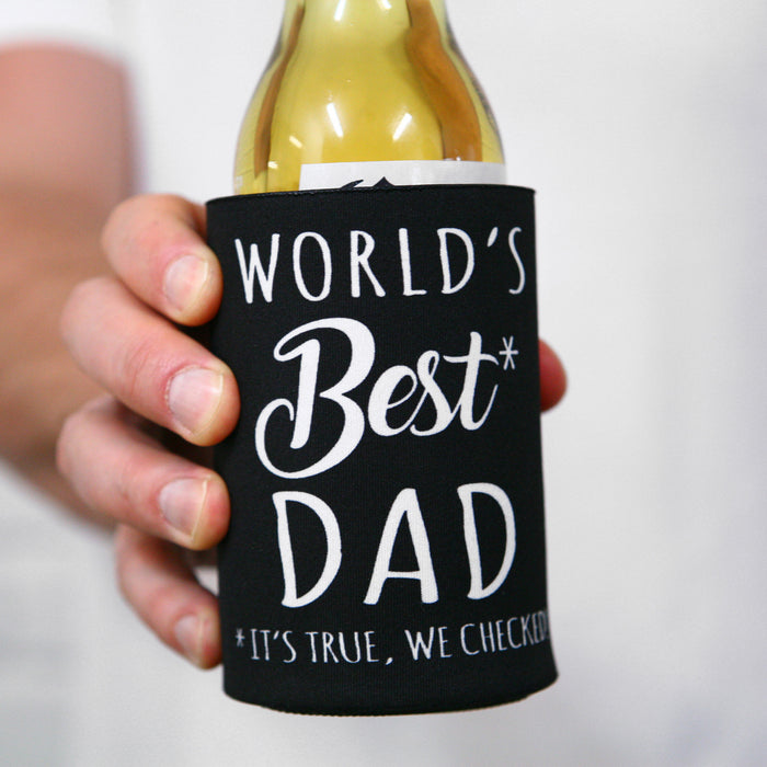 Black stubby holder printed with World’s Best Dad slogan on outdoor table