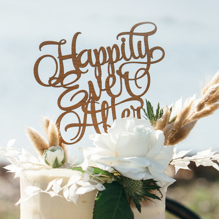 Cherry hardwood “Happily Ever After” cake topper on rustic wedding cake