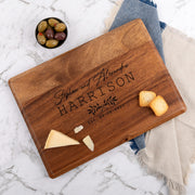 Engraved walnut wood wedding serving board with couple's names and date, perfect personalised gift