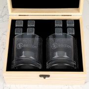 Wooden whiskey gift box open to reveal personalised glasses and reusable whiskey stones for corporate gifting.