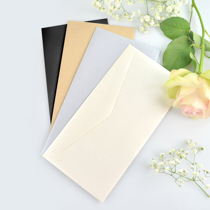 gold, black, white and silver envelops