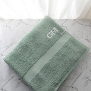 Oversized bath sheet in sage cotton, featuring custom initials and plush texture for everyday comfort.