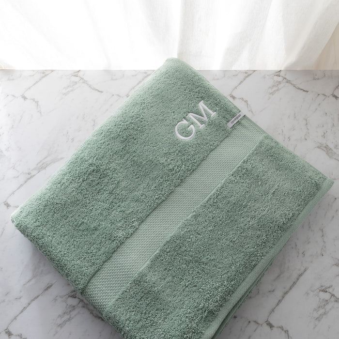 Oversized bath sheet in sage cotton, featuring custom initials and plush texture for everyday comfort.