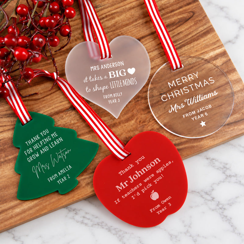 Personalised acrylic teacher Christmas decorations in frosted, clear, green and red designs.