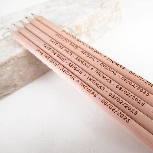 Customised engraved wooden save the date pencils.