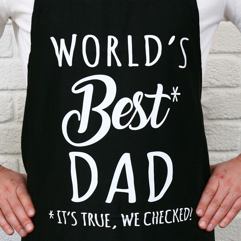 Father wearing World’s Best Dad BBQ apron while cooking at the grill