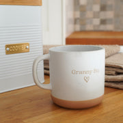 White ribbed cookie tin with gold badge and custom mug