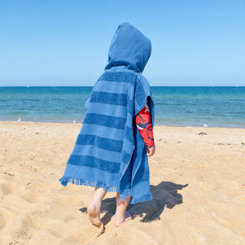 Personalised kids beach towel poncho in denim blue with cosy hood and absorbent cotton terry, a practical Christmas gift.