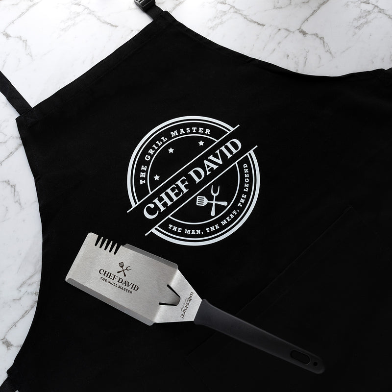 Personalised BBQ hamper with custom apron and engraved stainless steel BBQ tool featuring The Grill Master design.