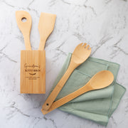Custom engraved bamboo utensil holder with spoon, spatula, fork, and spaghetti measuring spoon