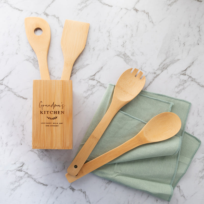 Custom engraved bamboo utensil holder with spoon, spatula, fork, and spaghetti measuring spoon