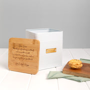 Gift-wrapped personalised cookie tin with kraft paper and white satin ribbon, perfect for special occasions.