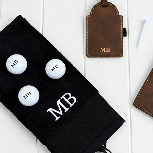 Personalised golf accessory gift set with initialled score card holder, golf tee tag, golf balls and cotton towel