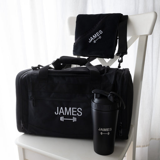 Personalised gym hamper with an embroidered sports bag, engraved protein shaker and matching black gym towel.
