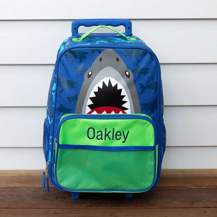 Personalised shark trolley case with embroidered child's name and shark design on front.