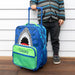 Child standing next to custom shark rolling suitcase with extended handle.