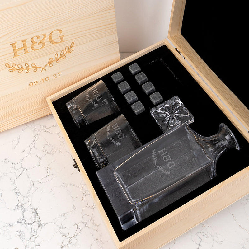 Custom engraved whiskey decanter set with names and date, a unique anniversary gift presented in a wooden gift box