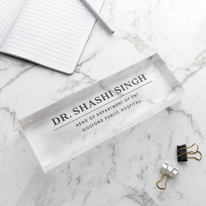 Custom acrylic desk sign available in black or white UV printed text