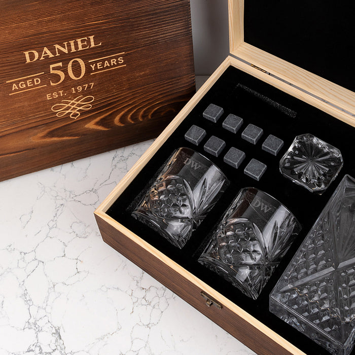 Custom engraved scotch glass set with initials, whiskey stones, and decanter in a wooden gift box for whiskey lovers