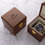 Custom single watch box made from premium walnut wood with engraved lid, gold clasp and velvet watch cushion.