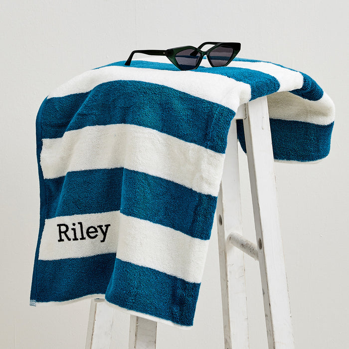 Teal striped personalised towel for kids, featuring black name stitching for easy identification