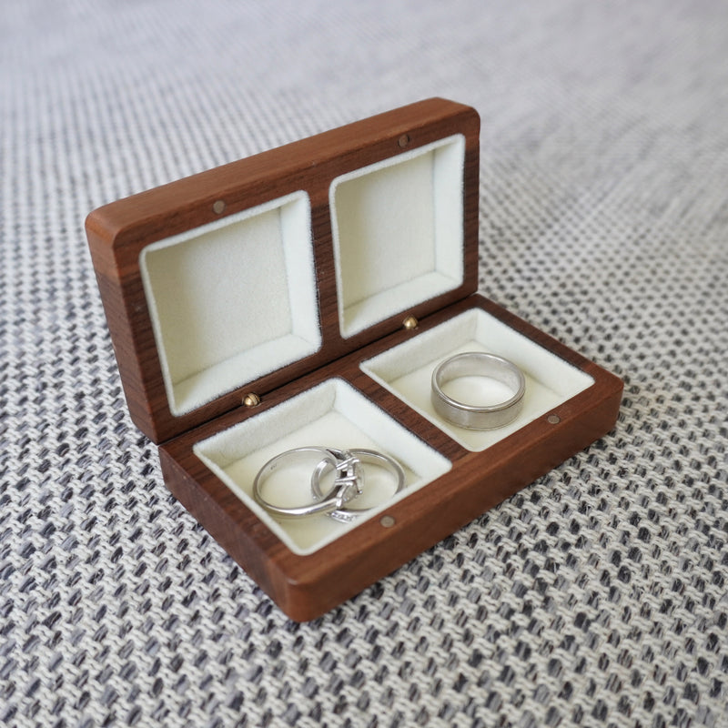Open walnut wedding ring box with velvet lining and two ring compartments